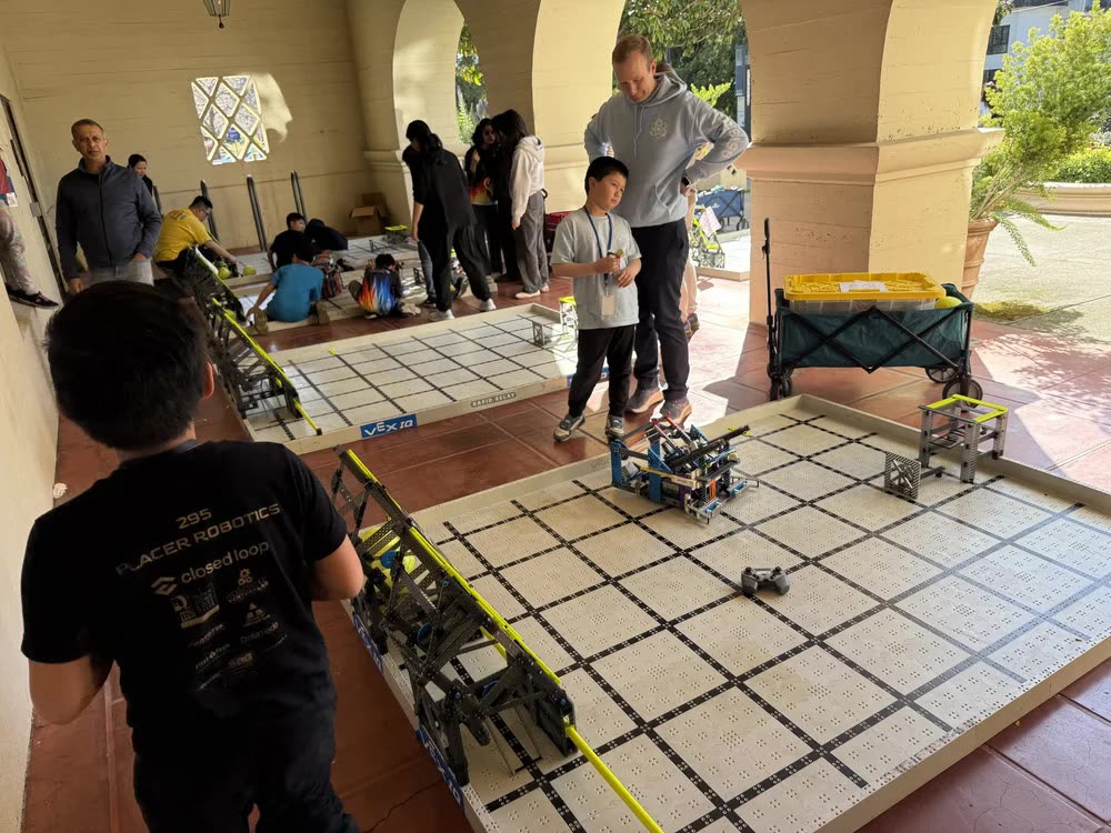 Teams driving robots on practice fields under the Clark Kerr arcade