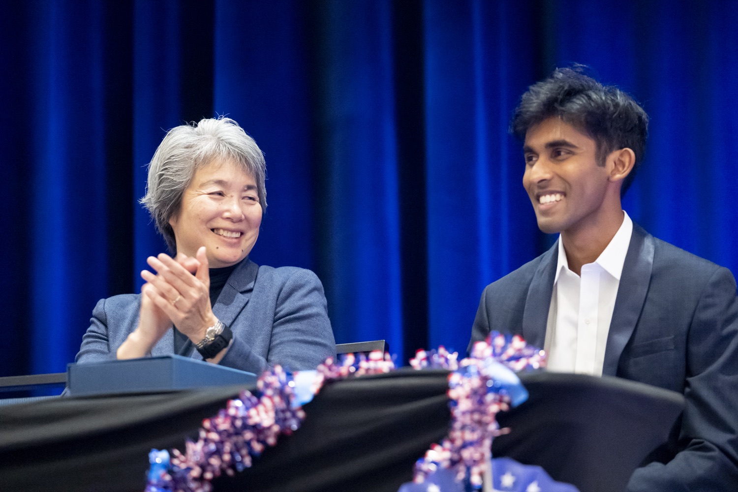 Dean Tsu-Jae King Liu and Arya Sasikumar on stage at the One World closing ceremony