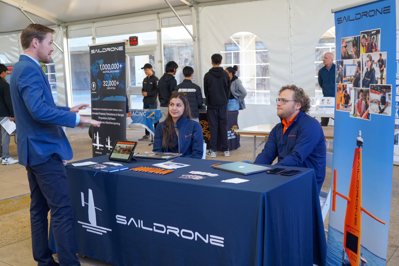 Saildrone booth with an orange wing sail model at the Expo