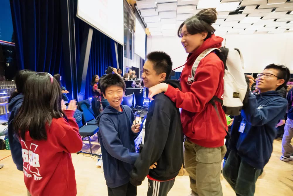 Students celebrating together after a match at One World