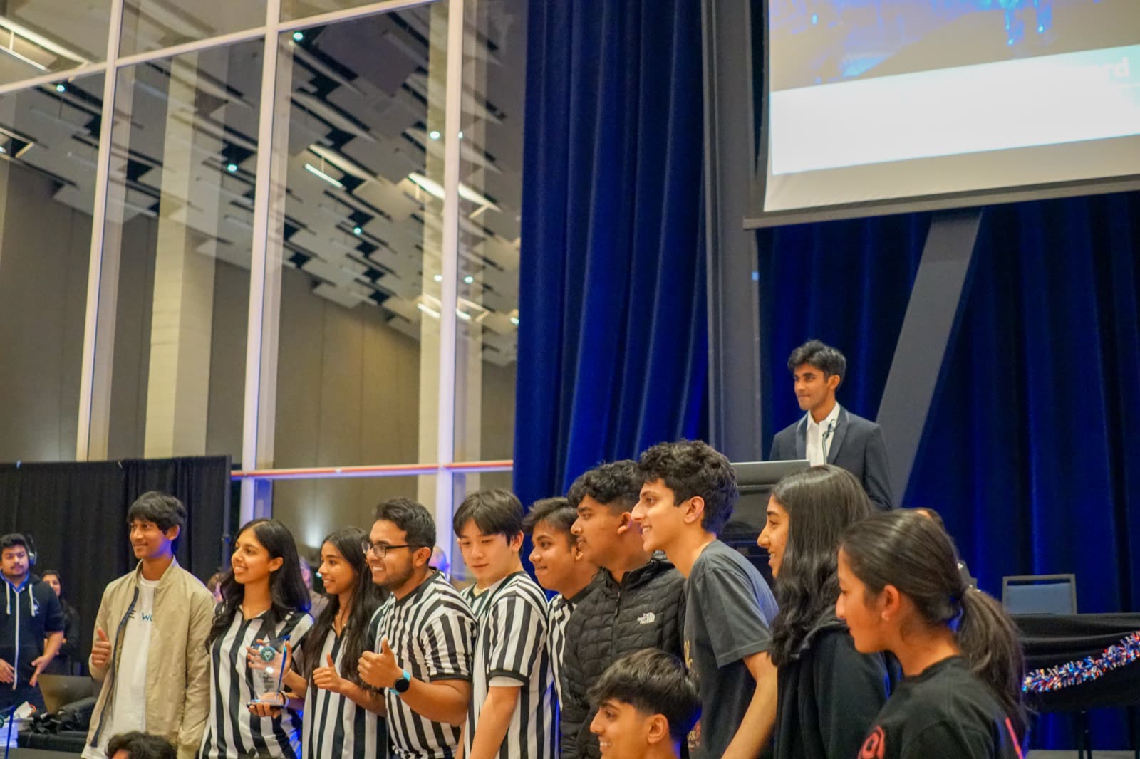 The volunteer team lined up on stage at the closing ceremony