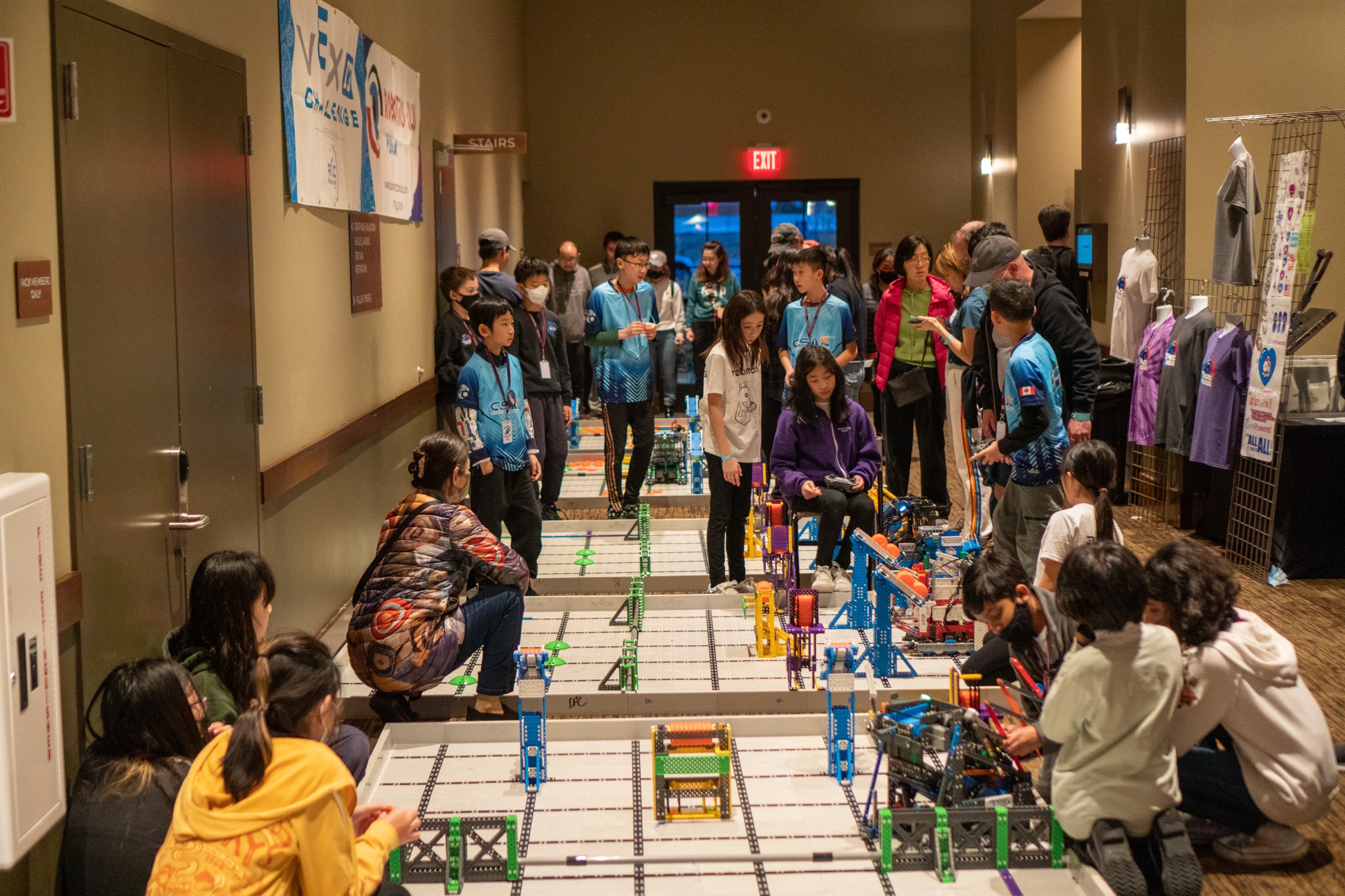 A packed corridor of practice fields at the Robolabs Pacific Open Championship in 2023, teams driving and tuning robots between matches