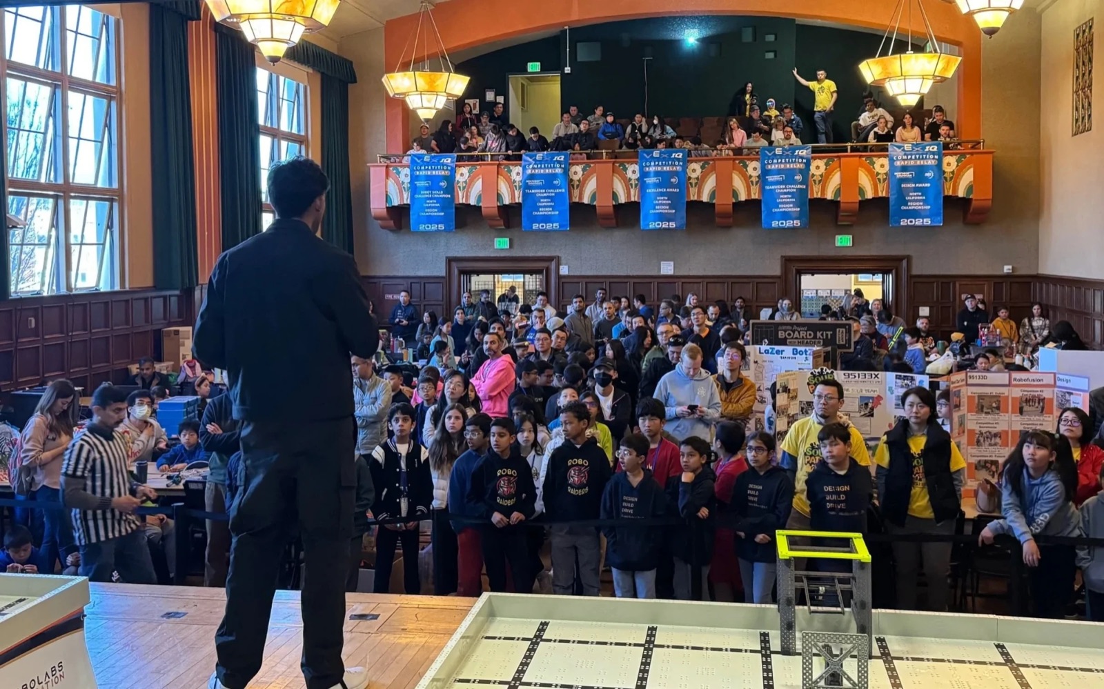 Arya Sasikumar on stage addressing the packed hall at the NorCal championship